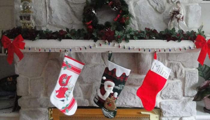 three stockings hanging by fireplace