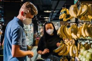 masked couple shopping