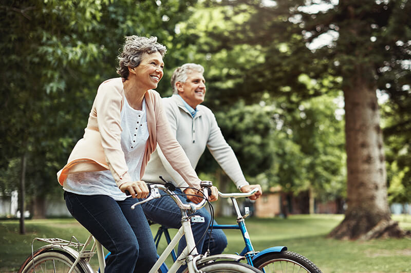 senior couple riding bikes together