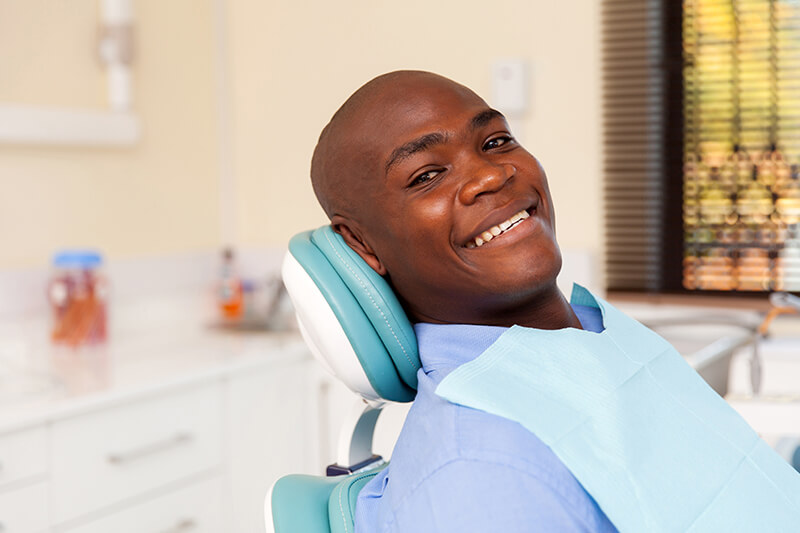 smiling man sitting in a dental chair