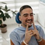 Man holding invisalign clear aligners for orthodontics