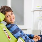 young boy in dental chair for routine dental visit for children