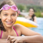 child wearing braces while swimming after consultation to determine if a child needs braces