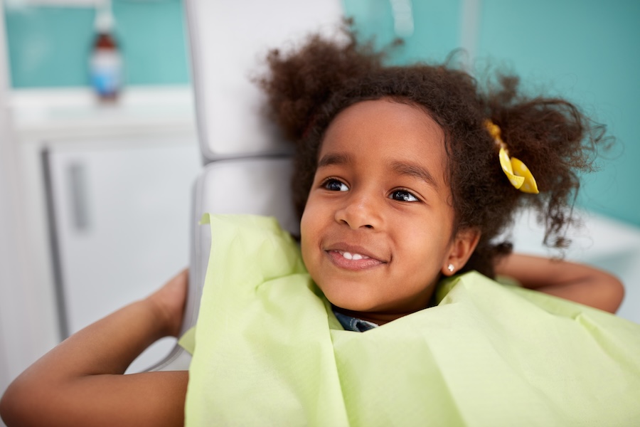 child in dental chair at family dentist