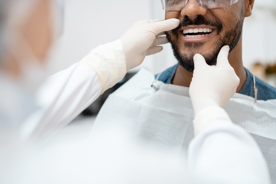 man at dentist discussing professional teeth whitening options
