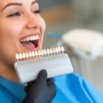 woman at dentist getting shade matched for porcelain veneers