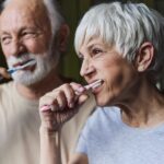 senior couple brushing their teeth for senior dental care