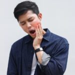 man suffering from TMJ pain and TMJ dysfunction