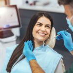 woman at dentist after dental bonding vs bioclear treatment