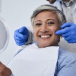 woman at dentist after dental bonding vs bioclear treatment